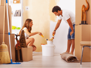 Couple painting a wall in home